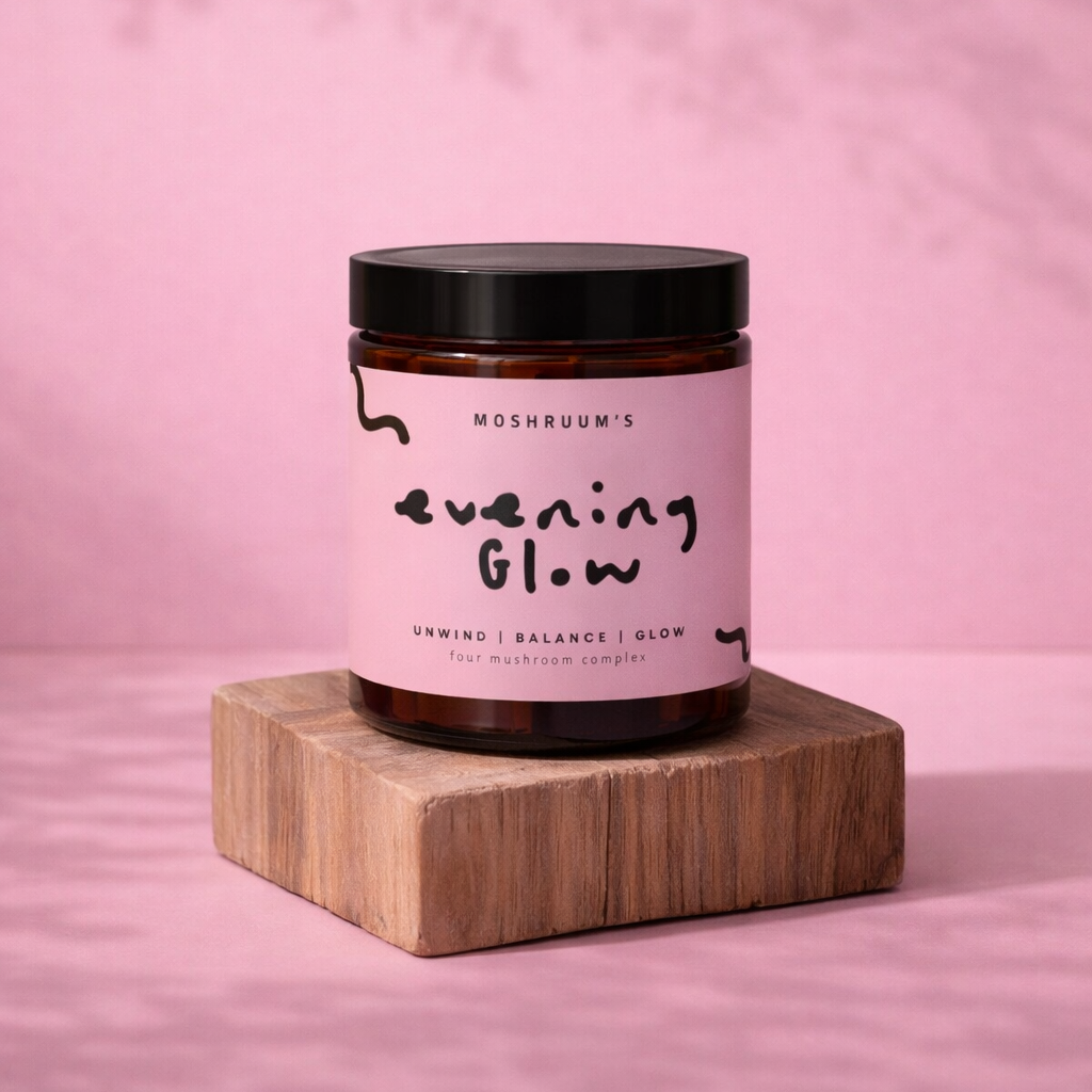 Jar of 'Evening Glow' on a wooden block with a pink background