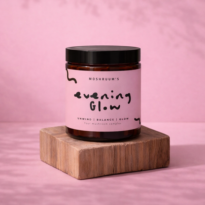Jar of 'Evening Glow' on a wooden block with a pink background