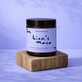 Jar labeled 'Lion's Mane' on a wooden block with a purple gradient background