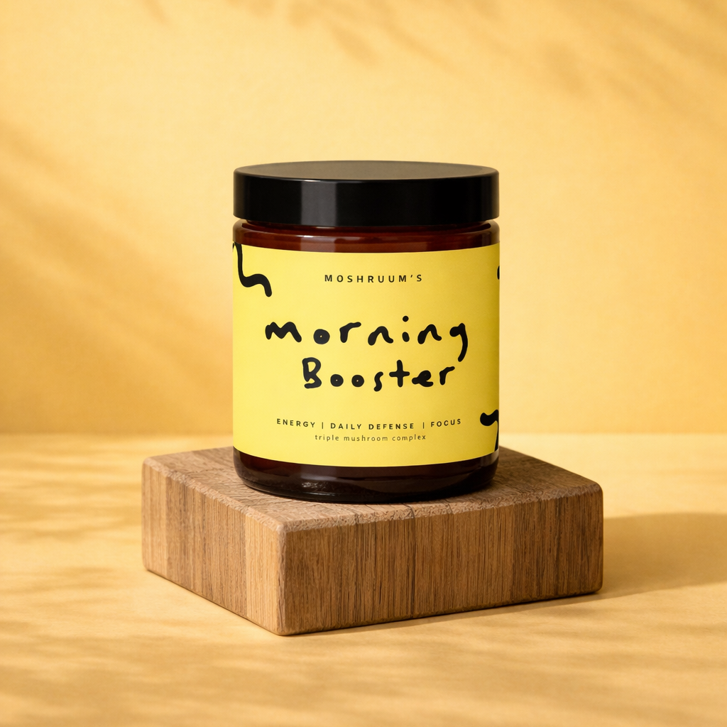 Jar labeled 'Morning Booster' triple mushroom complex powder on a wooden block with a yellow background